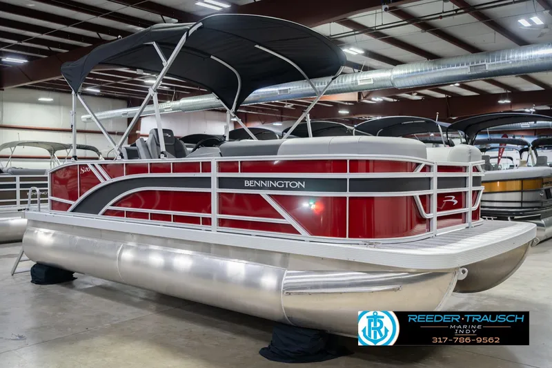 Slide: The Image of 2026 Bennington 20 SSR pontoon boat with red exterior in showroom. - 6