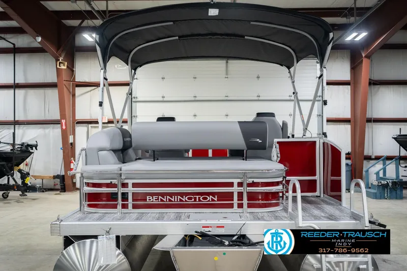Slide: The Image of 2026 Bennington 20 SSR pontoon boat in a showroom with canopy and seating. - 9