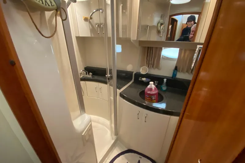 Slide: The Image of Interior of 2005 Carver 38 Super Sport yacht with beige sofa and elegant wood accents. - 19