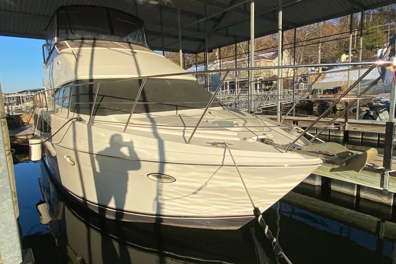 Slide: The Image of 2005 Carver 38 Super Sport yacht docked under a covered marina. - 2