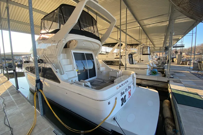 Slide: The Image of 2005 Carver 38 Super Sport yacht docked in a marina under a covered slip. - 4