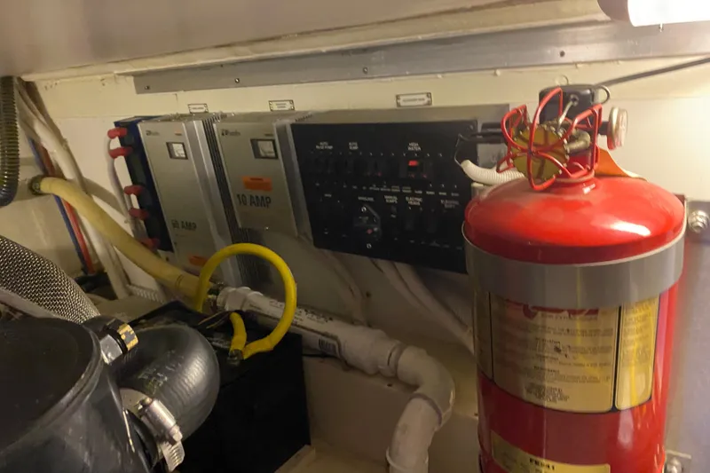 Slide: The Image of Engine room of 2005 Carver 38 Super Sport with fire extinguisher and electrical panel. - 47