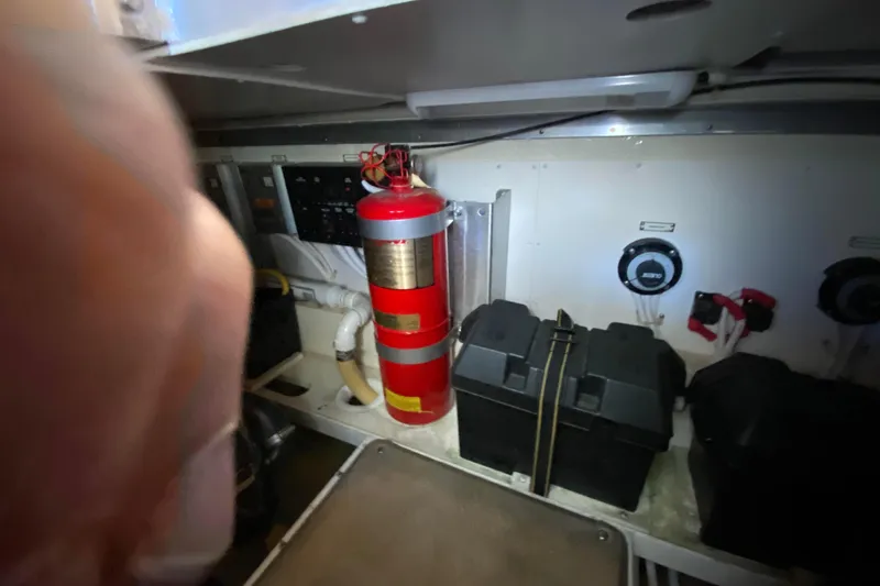 Slide: The Image of Engine room of 2005 Carver 38 Super Sport with fire extinguisher and battery boxes. - 50