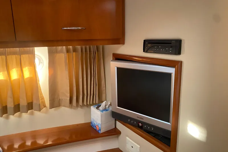 Slide: The Image of Interior of 2005 Carver 38 Super Sport yacht with wooden cabinetry and beige seating. - 23