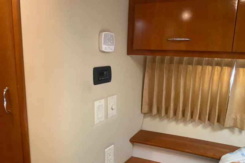 Slide: The Image of Electrical panel inside 2005 Carver 38 Super Sport yacht, featuring control switches and meters. - 24