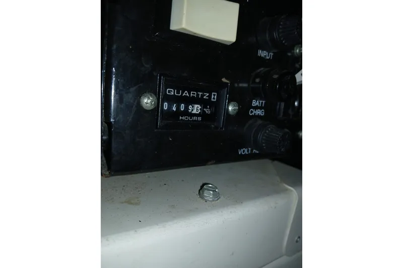 Slide: The Image of Engine compartment of a 2005 Carver 38 Super Sport boat, showing mechanical components and wiring. - 38