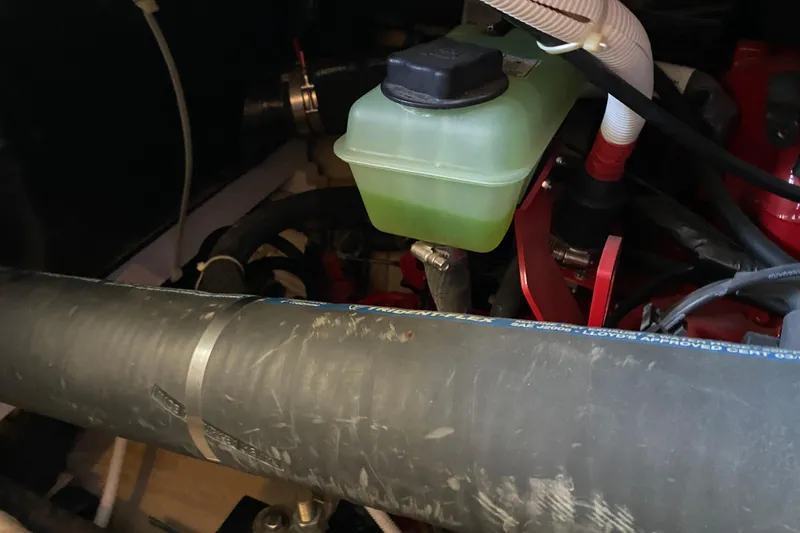 Slide: The Image of Engine compartment of 2005 Carver 38 Super Sport with coolant reservoir and hoses. - 46