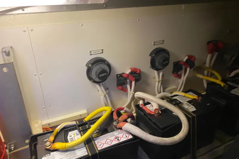 Slide: The Image of Battery compartment of a 2005 Carver 38 Super Sport boat, showing wiring and connections. - 48