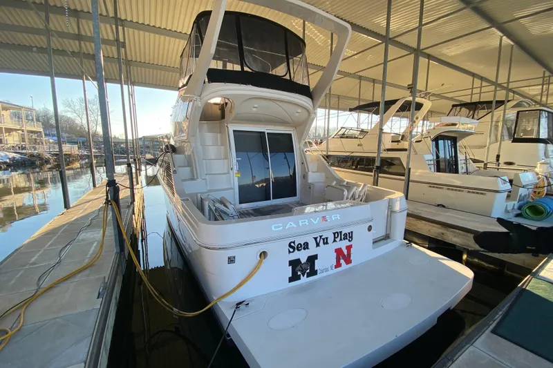 Slide: The Image of 2005 Carver 38 Super Sport yacht docked in a marina under a covered slip. - 5