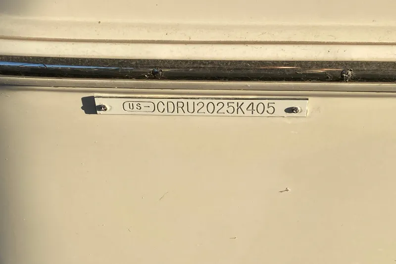 Slide: The Image of 2005 Carver 38 Super Sport boat docked, featuring "Sea Yu Play" name on the stern. - 6