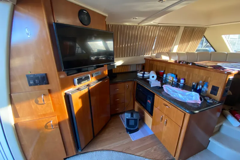 Slide: The Image of 2005 Carver 38 Super Sport yacht with stairs and sliding glass door under covered dock. - 8