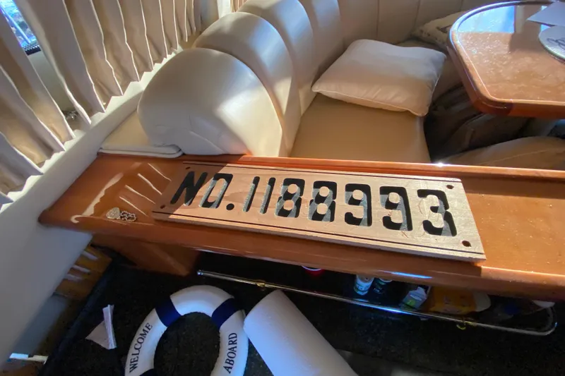 Slide: The Image of 2005 Carver 38 Super Sport yacht cockpit with white captain chairs and steering controls. - 9