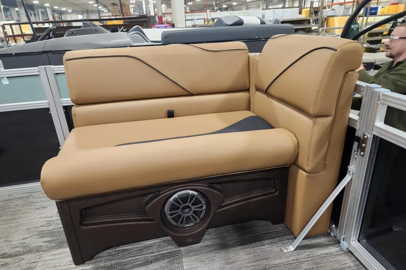 Slide: The Image of Luxurious seating on 2026 Avalon VENTURE CRUISE boat, featuring tan upholstery and integrated speaker. - 10