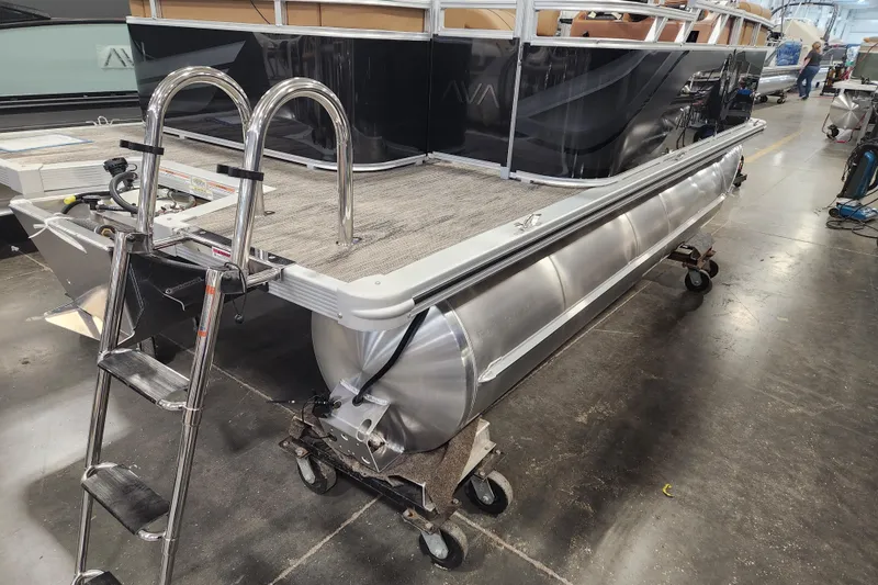 Slide: The Image of 2026 Avalon VENTURE CRUISE pontoon boat with ladder in a workshop setting. - 12