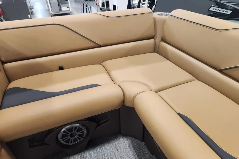 Slide: The Image of Luxurious tan seating in 2026 Avalon VENTURE CRUISE boat, featuring integrated speaker system. - 9