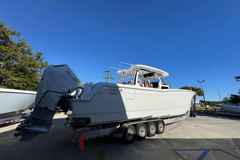 Slide: The Image of 2026 Caymas 44 CT boat on trailer under clear blue sky. - 10