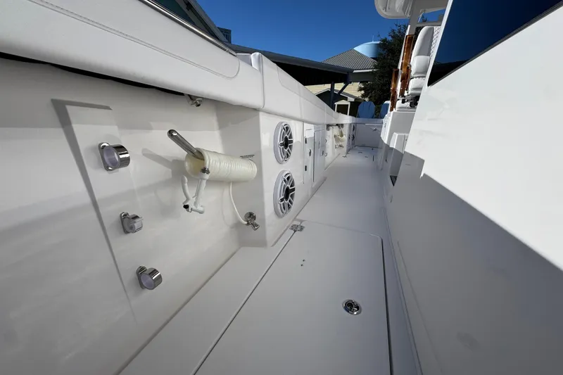 Slide: The Image of 2026 Caymas 44 CT boat deck with speakers and fishing rod holder. - 22