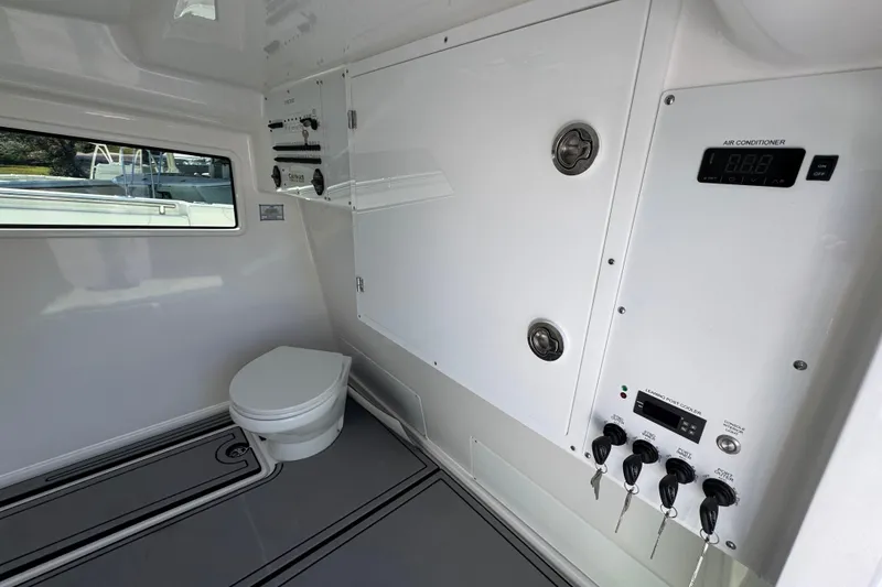 Slide: The Image of 2026 Caymas 44 CT boat interior with toilet and control panel. - 24