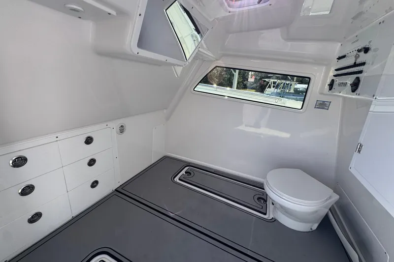 Slide: The Image of 2026 Caymas 44 CT boat interior with toilet and storage cabinets. - 25