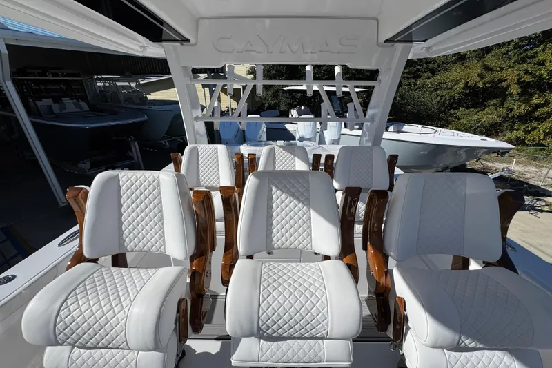 Slide: The Image of Luxury seating on 2026 Caymas 44 CT boat, featuring elegant white quilted upholstery. - 27