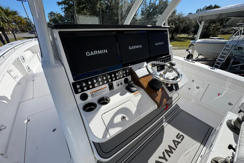 Slide: The Image of 2026 Caymas 44 CT boat helm with dual Garmin displays and modern controls. - 29