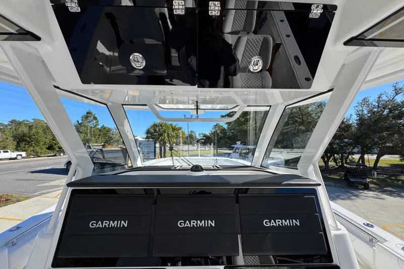 Slide: The Image of 2026 Caymas 44 CT boat cockpit with Garmin navigation displays and sleek design. - 31