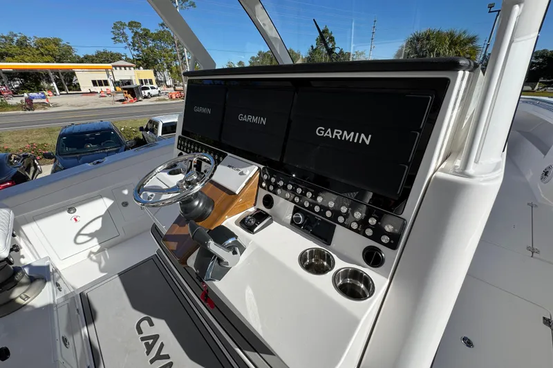 Slide: The Image of 2026 Caymas 44 CT boat helm with Garmin displays and modern controls. - 32