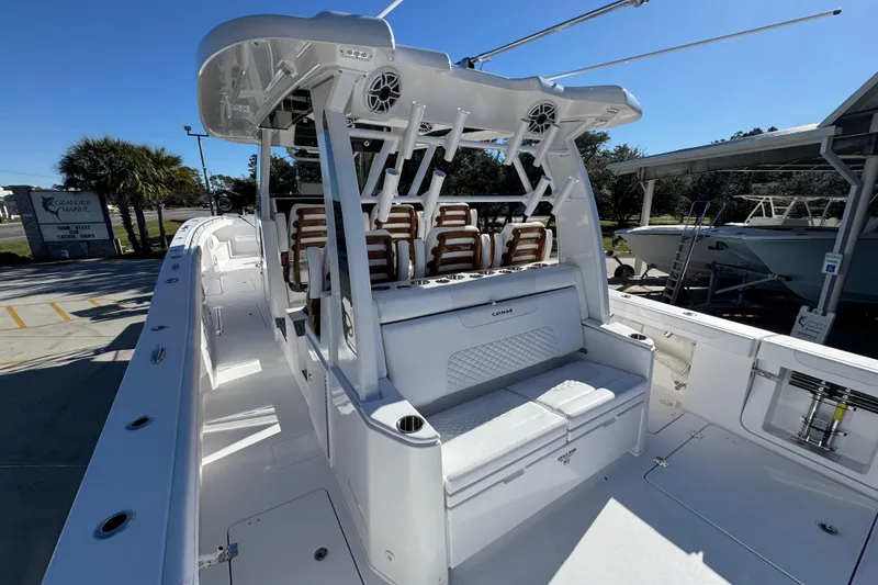 Slide: The Image of 2026 Caymas 44 CT boat with sleek white interior and seating, docked outdoors. - 35