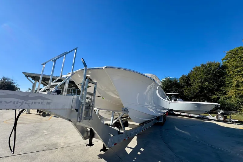 Slide: The Image of 2026 Caymas 44 CT boat on trailer under clear blue sky. - 4
