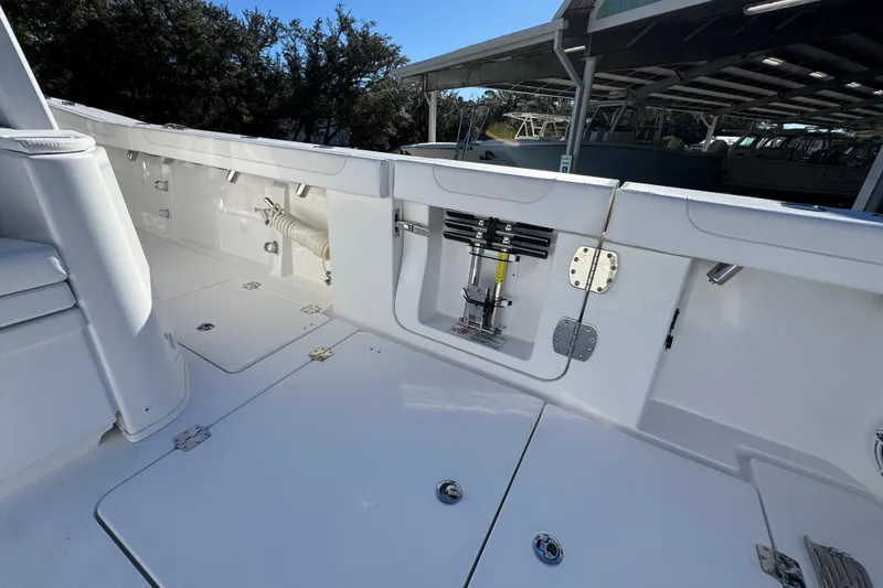 Slide: The Image of 2026 Caymas 44 CT boat deck with storage compartments and hydraulic system. - 40