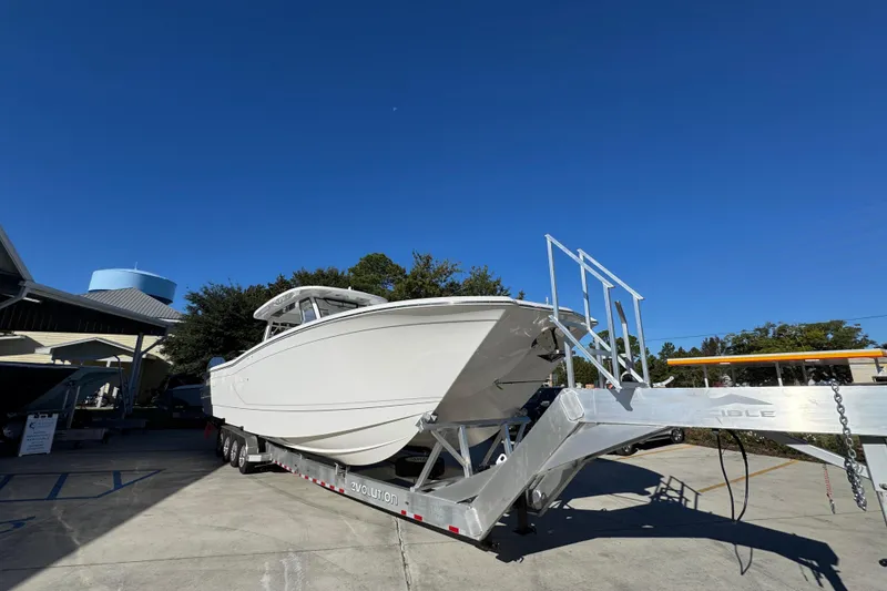Slide: The Image of 2026 Caymas 44 CT boat on trailer under clear blue sky. - 6