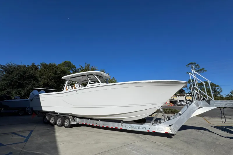 Slide: The Image of 2026 Caymas 44 CT boat on trailer under clear blue sky. - 7