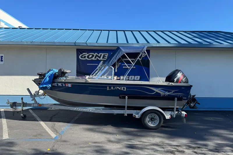 Slide: The Image of 2001 Lund 1700 Pro Sport boat on trailer, parked outside a building. - 1