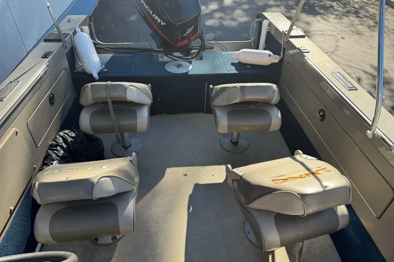 Slide: The Image of 2001 Lund 1700 Pro Sport boat interior with seating and Mercury engine. - 11