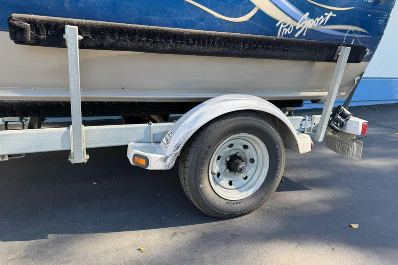 Slide: The Image of 2001 Lund 1700 Pro Sport boat on trailer, close-up of wheel and hull. - 2