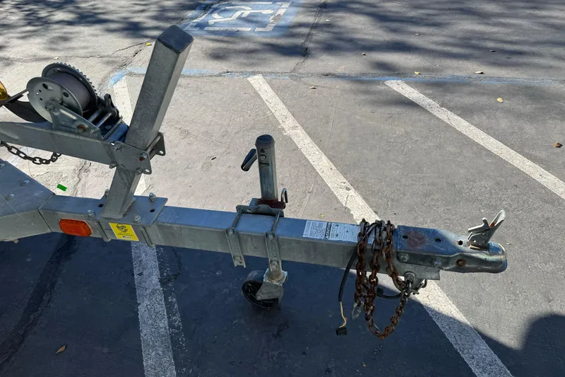 Slide: The Image of Trailer hitch and winch of a 2001 Lund 1700 Pro Sport boat in parking lot. - 4