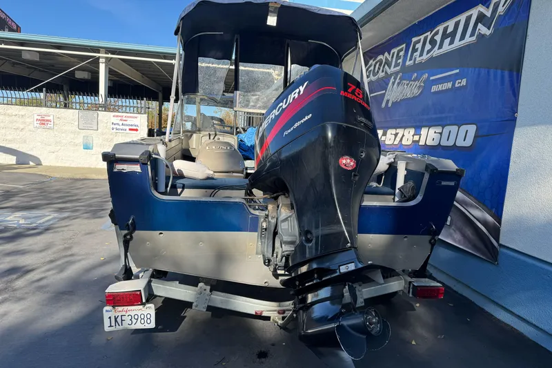 Slide: The Image of 2001 Lund 1700 Pro Sport boat with Mercury outboard motor in parking lot. - 7