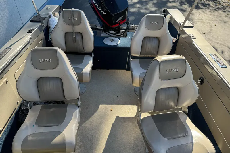 Slide: The Image of 2001 Lund 1700 Pro Sport boat interior with four seats and Mercury outboard motor. - 9