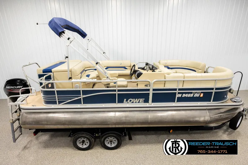 Slide: The Image of 2015 Lowe SS 210 pontoon boat with Mercury engine, beige seating, and blue accents. - 1