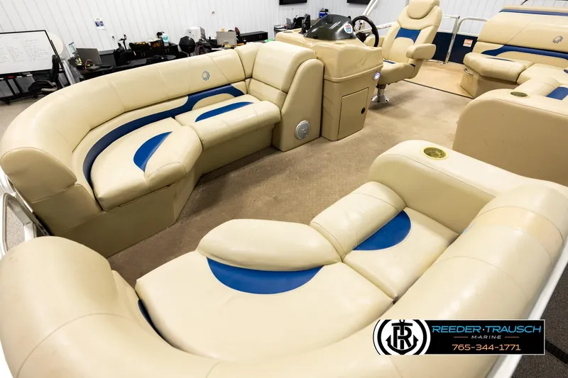 Slide: The Image of Interior of a 2015 Lowe SS 210 boat with beige and blue seating. - 10