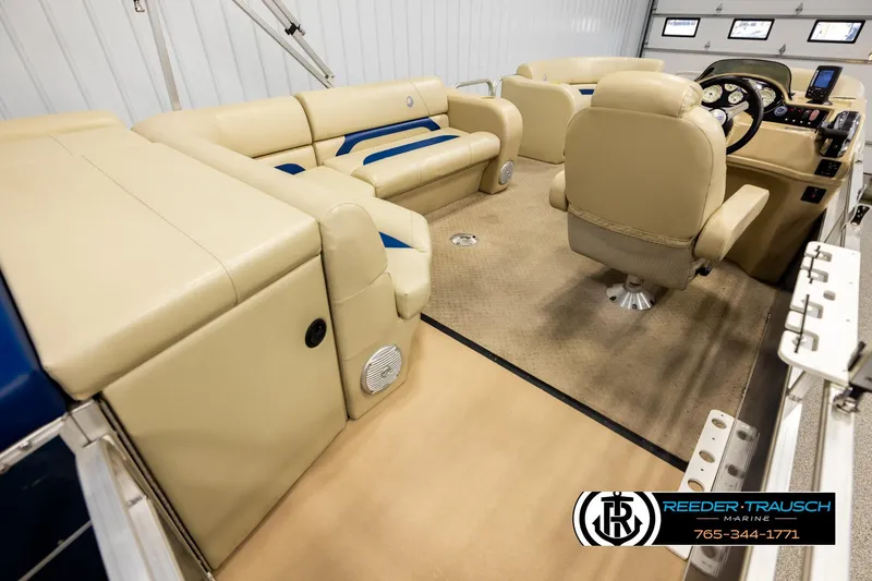 Slide: The Image of 2015 Lowe SS 210 pontoon boat interior with beige seating and steering console. - 12