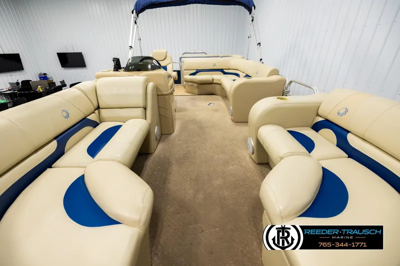 Slide: The Image of Interior of a 2015 Lowe SS 210 pontoon boat with beige and blue seating. - 13