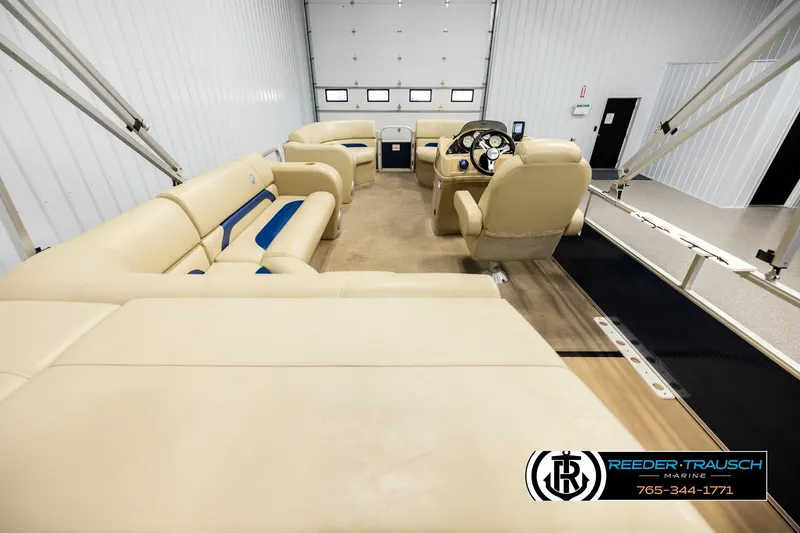 Slide: The Image of Interior of a 2015 Lowe SS 210 pontoon boat with beige seating and steering console. - 16