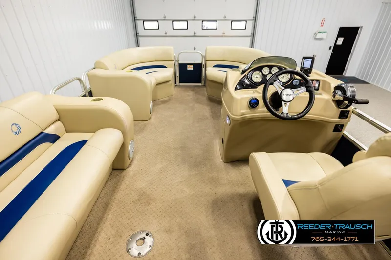 Slide: The Image of Interior of a 2015 Lowe SS 210 pontoon boat with beige seating and control panel. - 17