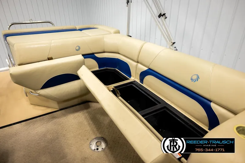 Slide: The Image of 2015 Lowe SS 210 boat interior with beige and blue seating, storage compartments open. - 21