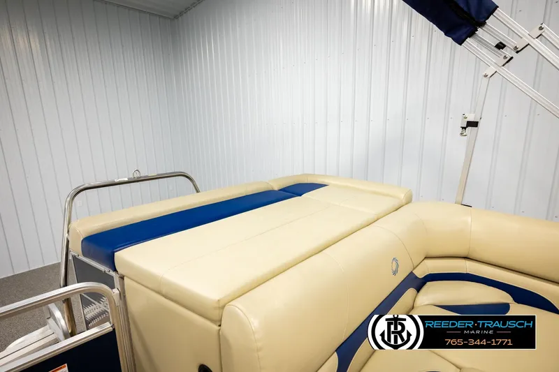 Slide: The Image of 2015 Lowe SS 210 boat interior with beige and blue seating, Reeder-Trausch Marine logo visible. - 22