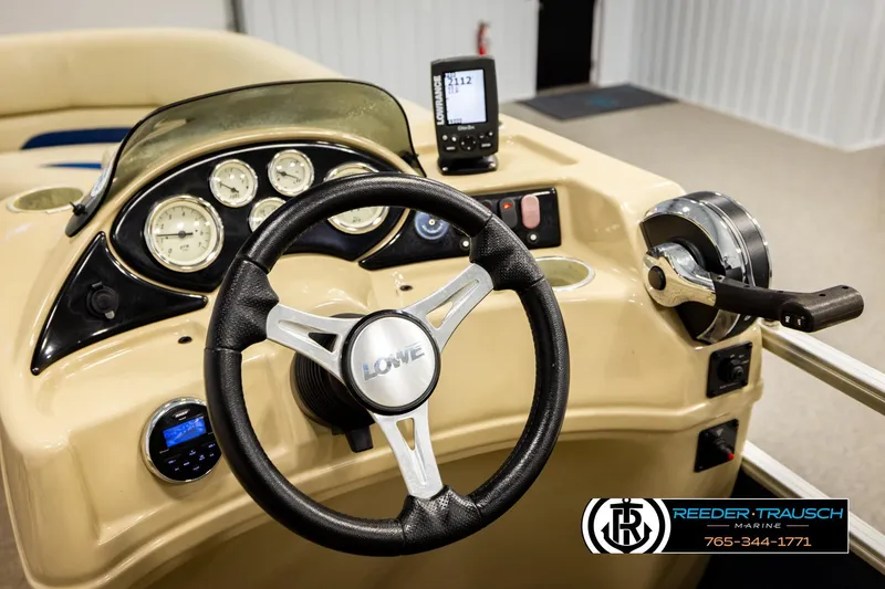 Slide: The Image of Steering console of a 2015 Lowe SS 210 boat with gauges and controls. - 25