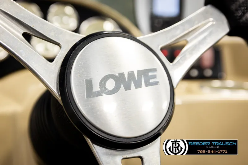 Slide: The Image of Steering wheel of 2015 Lowe SS 210 boat with Reeder-Trausch Marine logo. - 26