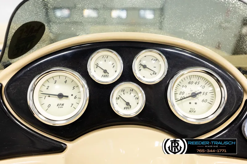 Slide: The Image of Dashboard of a 2015 Lowe SS 210 boat with gauges and Reeder-Trausch Marine logo. - 28