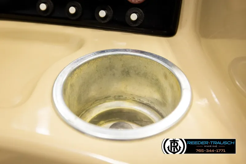Slide: The Image of Cup holder on 2015 Lowe SS 210 boat dashboard, Reeder-Trausch Marine logo visible. - 31